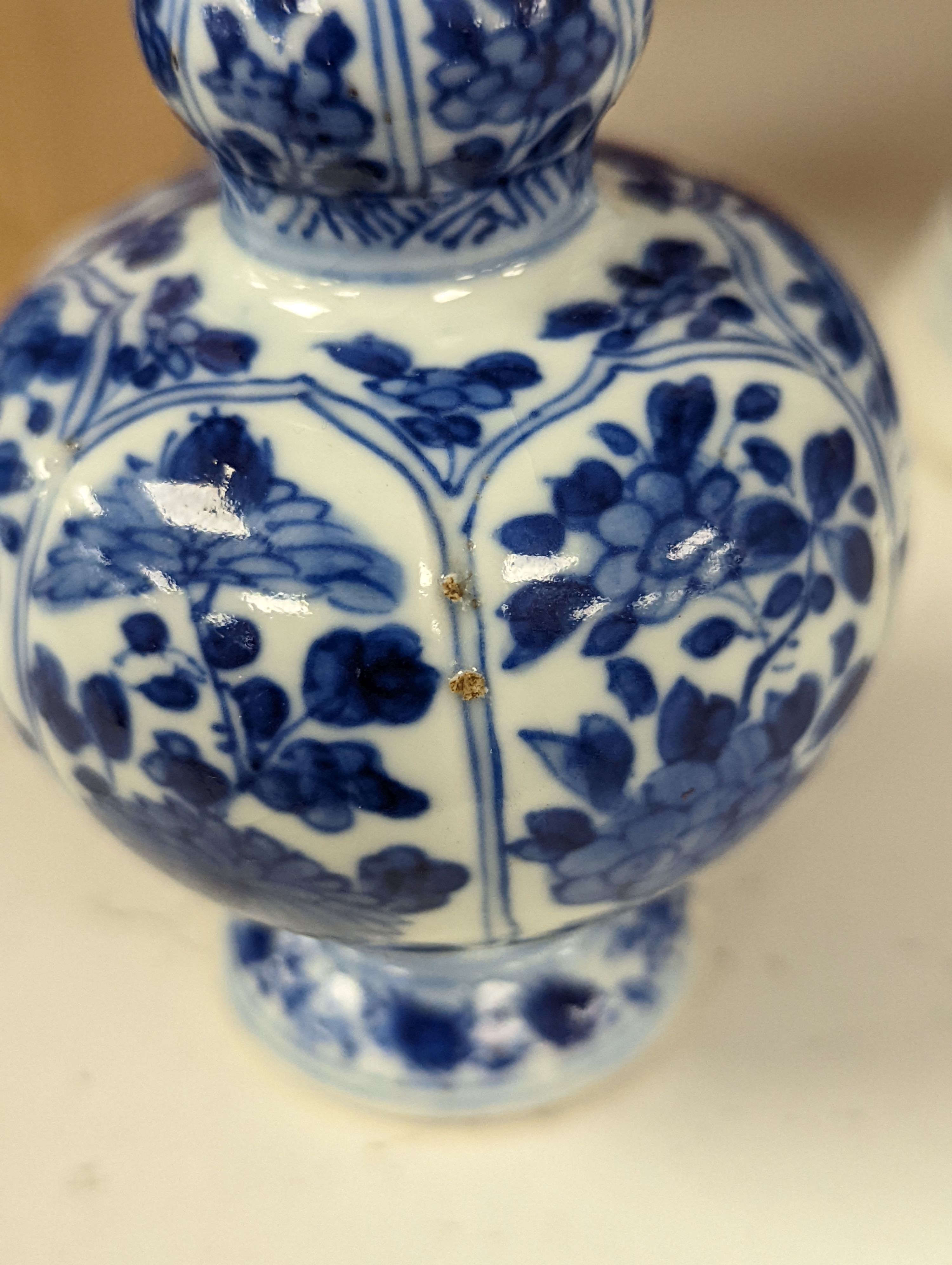 A Chinese blue and white vase and cover, Kangxi mark, 19th century, 26.5cm tall, and a Chinese Kangxi period small vase (2)